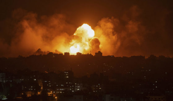 Fire and smoke rise following an Israeli airstrike in Gaza City on Sunday.