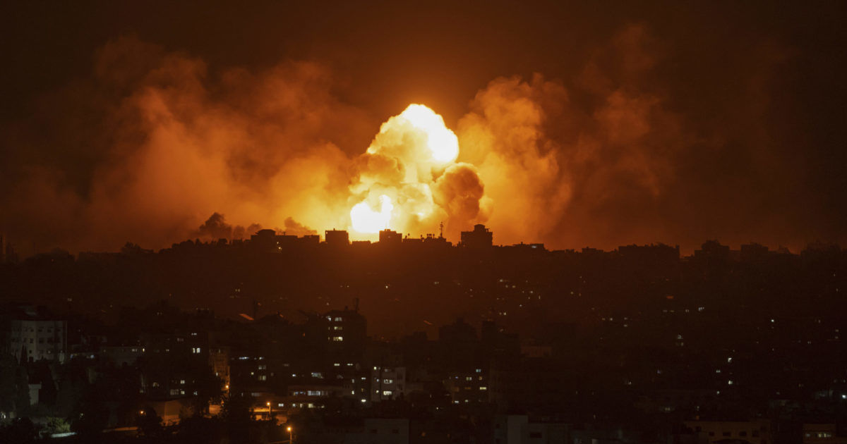 Fire and smoke rise following an Israeli airstrike in Gaza City on Sunday.