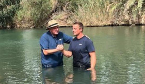 Survivalist and TV star Bear Grylls is baptized in the Jordan River.