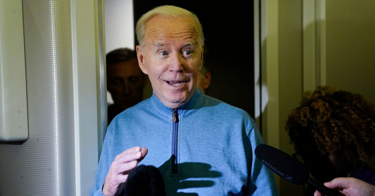 President Joe Biden talks to reporters aboard Air Force One during a refueling stop in at Ramstein Air Base in Germany on Wednesday as he traveled back from Israel to Washington.