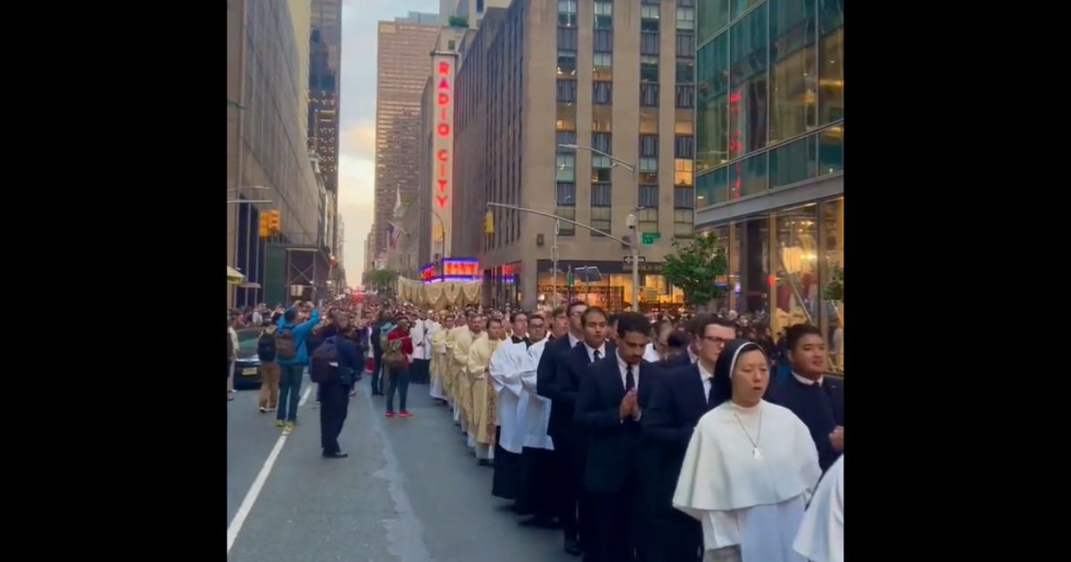 Catholics sing hymns as they march through New York City.
