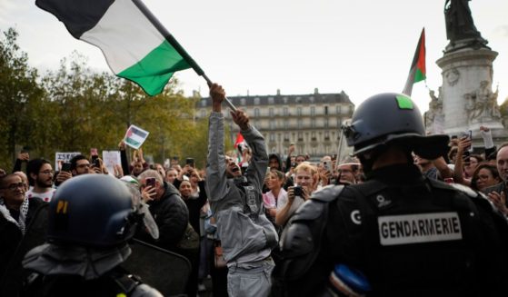 A protester waves a Palestinian flag during a confrontation with police in Paris on Thursday.