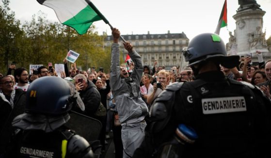 A demonstrator holds a Palestinian flag during a pro-Palestinian protest in Paris, France, on Thursday. The French government has announced a ban on any pro-Palestinian protest across the country.