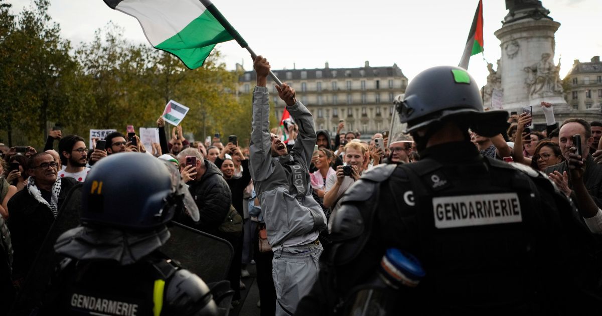 A demonstrator holds a Palestinian flag during a pro-Palestinian protest in Paris, France, on Thursday. The French government has announced a ban on any pro-Palestinian protest across the country.