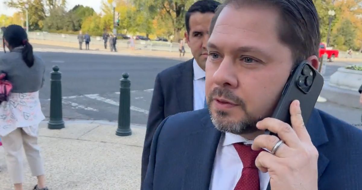 Arizona Rep. Ruben Gallego holds his phone as he's confronted by Ben Bergquam of Real America’s Voice in Washington.