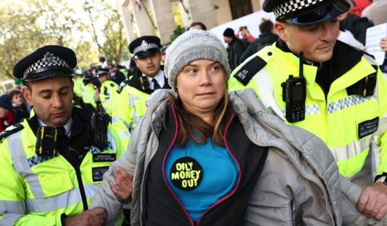 Swedish climate activist Greta Thunberg reacts as she is taken toward a police van after protesting outside the InterContinental London Park Lane during the "Oily Money Out" demonstration organized by Fossil Free London and Greenpeace on the sidelines of the opening day of the Energy Intelligence Forum in London on Tuesday.