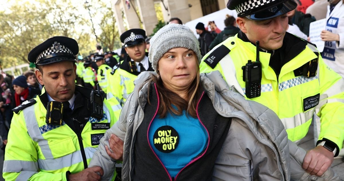 Swedish climate activist Greta Thunberg reacts as she is taken toward a police van after protesting outside the InterContinental London Park Lane during the "Oily Money Out" demonstration organized by Fossil Free London and Greenpeace on the sidelines of the opening day of the Energy Intelligence Forum in London on Tuesday.