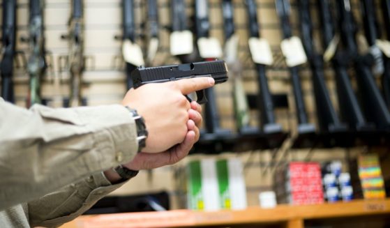 In this stock photo, a salesman holds a gun in a gun store. On Sunday, a man attempted to rob East Bay Firearms in Livermore, California, with a hammer.