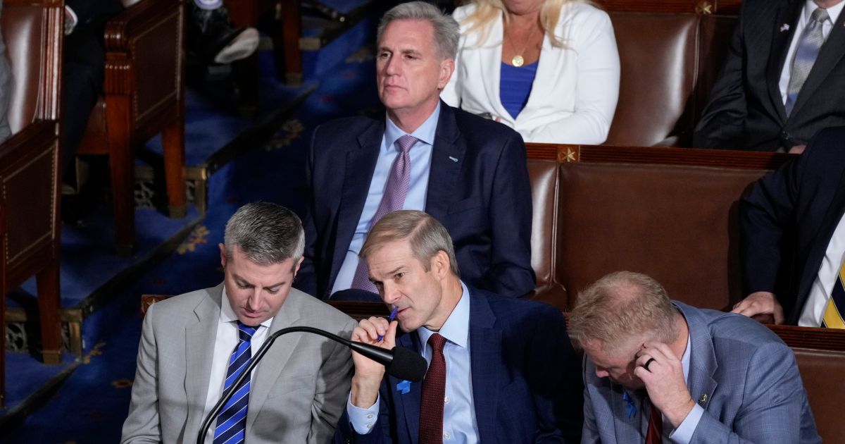Rep. Jim Jordan, bottom center, listens at the end of the second ballot as Republicans try to elect him to be the new House speaker at the Capitol in Washington on Wednesday. The former speaker, Rep. Kevin McCarthy, looks on at top center.