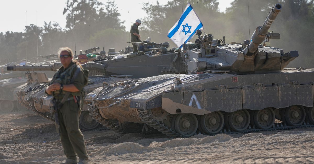 Israeli soldiers working on a tank
