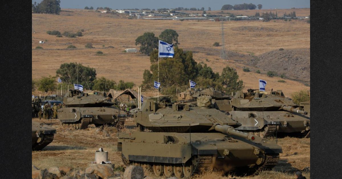 Israeli Merkava tanks are positioned in the upper Galilee in northern Israel near the border with Lebanon Wednesday. Israel appeared to be readying for a possible ground invasion of Gaza, but faces the threat of a multi-front war after also coming under rocket attack from militant groups in neighboring Lebanon and Syria.