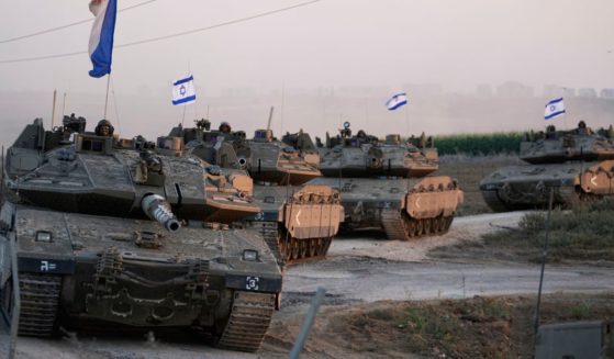 Israeli tanks are mobilized towards the Gaza strip border in southern Israel on Thursday. Israel has dropped flyers over the Gaza Strip telling residents to evacuate or risk harm.