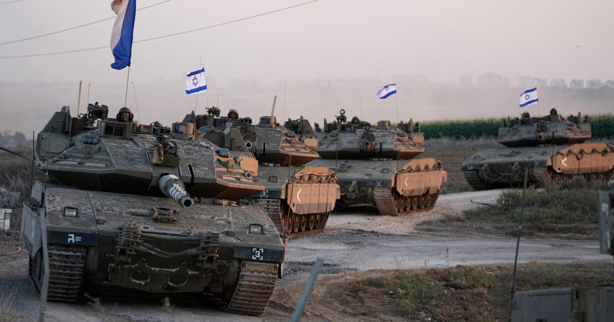 Israeli tanks are mobilized towards the Gaza strip border in southern Israel on Thursday. Israel has dropped flyers over the Gaza Strip telling residents to evacuate or risk harm.