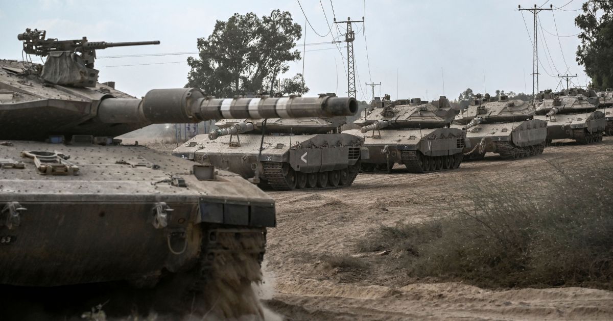 Israeli Merkava tanks deploy along the border with the Gaza Strip in southern Israel on Friday.