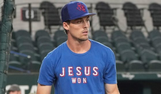 The Texas Rangers' Evan Carter wears a "Jesus Won" shirt during batting practice for the team's game against the Oakland Athletics in Arlington, Texas, on Sept. 8.