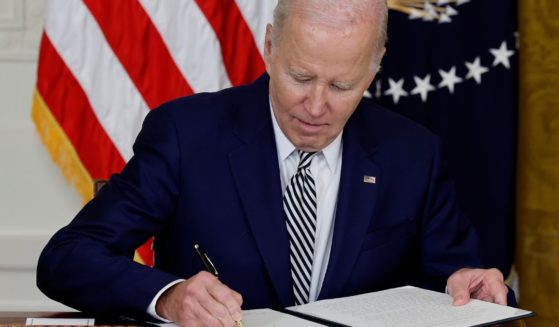On Monday, President Joe Biden signs an executive order guiding his administration's approach to artificial intelligence during an event in the East Room of the White House in Washington, D.C.