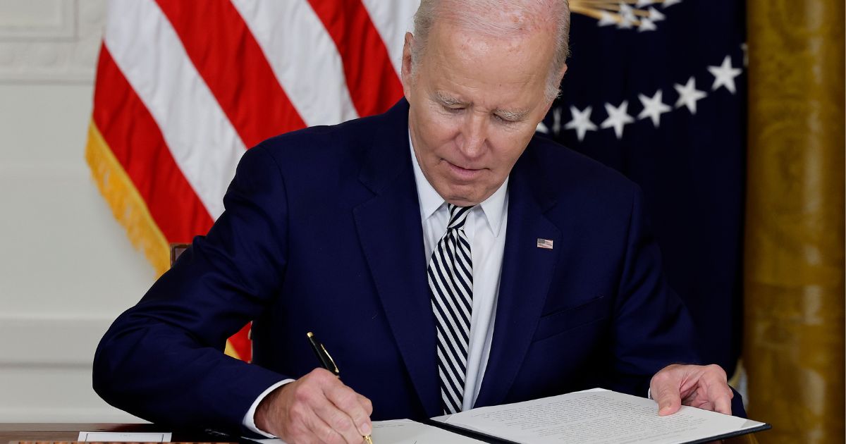 On Monday, President Joe Biden signs an executive order guiding his administration's approach to artificial intelligence during an event in the East Room of the White House in Washington, D.C.
