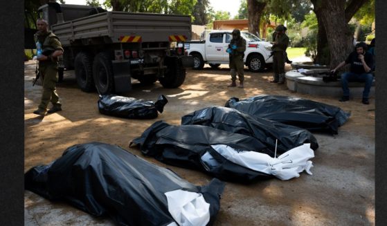The bodies of four Israeli civilians killed days earlier in an attack by Hamas militants wait to be collected on Tuesday in Kfar Aza, israel. Israel has sealed off Gaza and conducted airstrikes on Palestinian territory after an attack by Hamas killed hundreds and took more than 100 hostages.