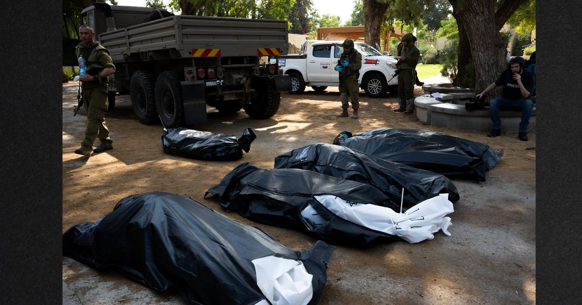 The bodies of four Israeli civilians killed days earlier in an attack by Hamas militants wait to be collected on Tuesday in Kfar Aza, israel. Israel has sealed off Gaza and conducted airstrikes on Palestinian territory after an attack by Hamas killed hundreds and took more than 100 hostages.