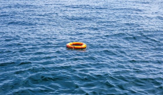 A stock photo shows an orange lifesaver ring floating in water.