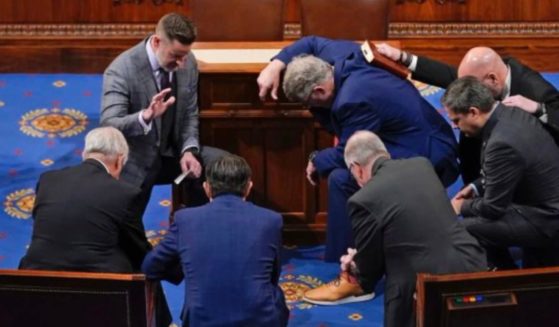 Newly elected Speaker of the House Mike Johnson joined other congressmen for a prayer on the House floor in January.
