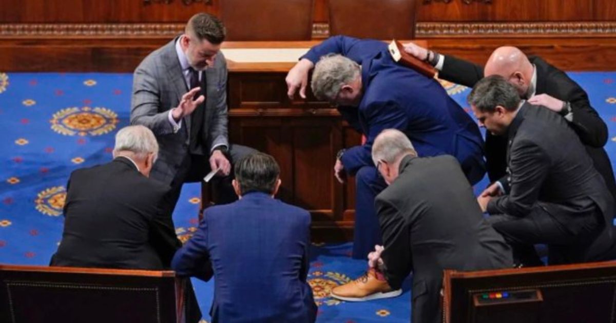 Newly elected Speaker of the House Mike Johnson joined other congressmen for a prayer on the House floor in January.