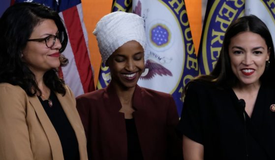 Reps. Rashida Tlaib, left, Ilhan Omar, middle, and Alexandria Ocasio-Cortez, right, listen during a news conference at the U.S. Capitol in Washington, D.C., on July 15, 2019. This week the three representatives have made comments in support of the actions of Hamas towards Israel, and the White House appeared to condemn their remarks on Tuesday.