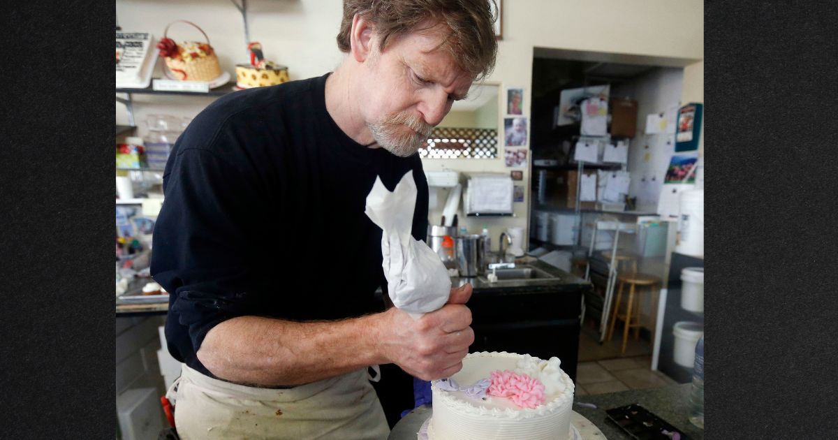 Conservative Christian baker Jack Phillips is seen decorating a cake inside his store in Lakewood, Colorado in a file photo from 2014. After winning a battle that went to the Supreme Court over his right to not bake a cake for a same-sex couple, Phillips is again being sued, this time for refusing to bake a cake celebrating someone's gender transition.