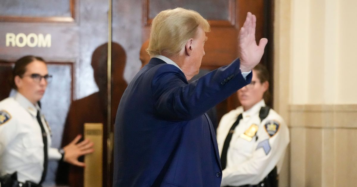 Former President Donald Trump waves as he returns to the courtroom after a break in his civil business fraud trial at New York Supreme Court in New York City on Wednesday.