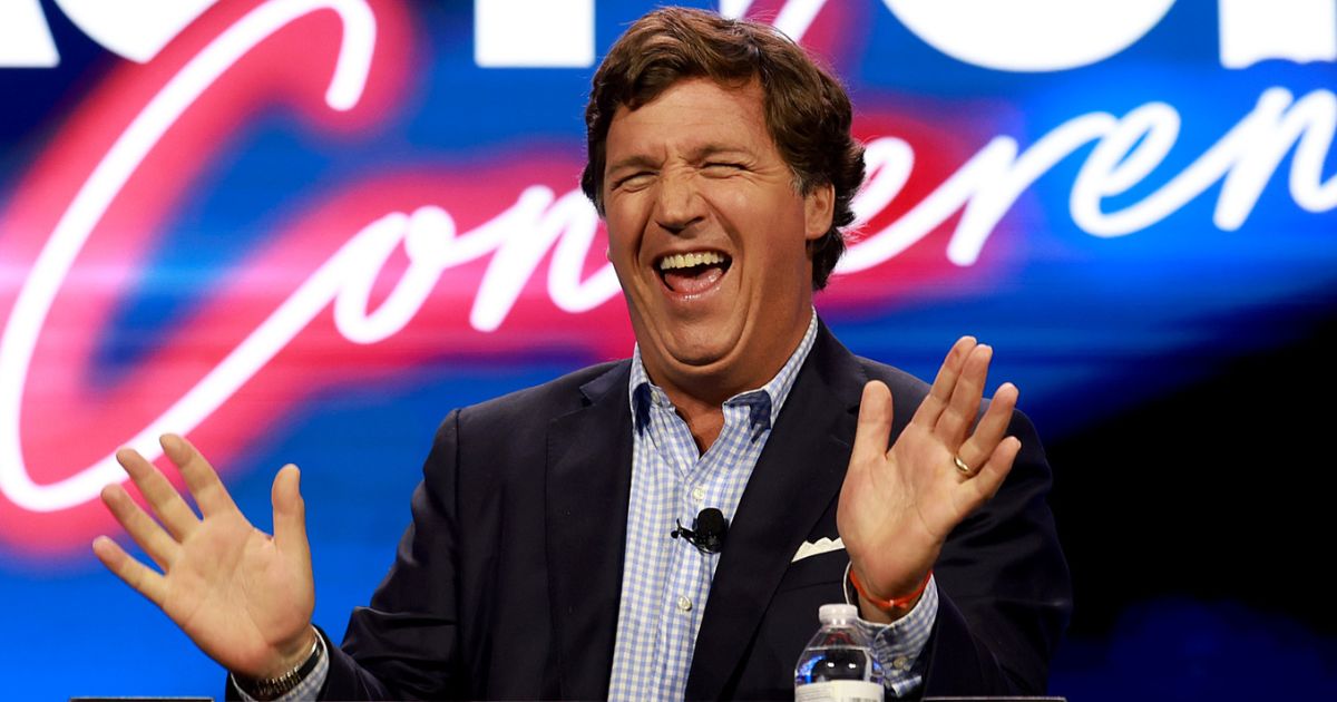 Tucker Carlson speaks at the Turning Point Action conference in West Palm Beach, Florida, on July 15. On Friday, Carlson signed his first advertising deal for his new media company.