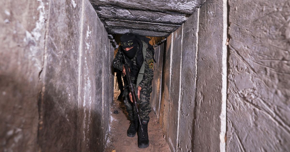 A member of the Palestinian Islamic Jihad terrorist group walks in a tunnel in the Gaza Strip during a media tour on April 17, 2022.