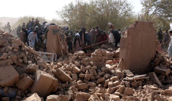 Afghan men search for victims after an earthquake in Zenda Jan district in Herat province, of western Afghanistan, Sunday.