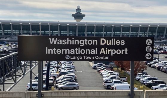 The terminal at Dulles International Airport stands behind a Metrorail station sign, Nov. 2, 2022, in Chantilly, Virginia.
