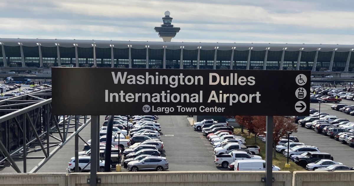 The terminal at Dulles International Airport stands behind a Metrorail station sign, Nov. 2, 2022, in Chantilly, Virginia.