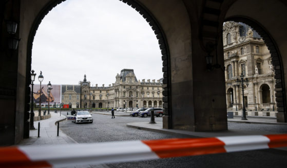 Police officers stand guard outside the Louvre Museum in Paris on Saturday.