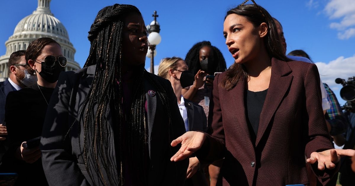 Congressional Progressive Caucus members Rep. Cori Bush and Rep. Alexandria Ocasio-Cortez talk to reporters before a vote to keep the federal government open until early December outside the U.S. Capitol on Sept. 30, 2021, in Washington, D.C.
