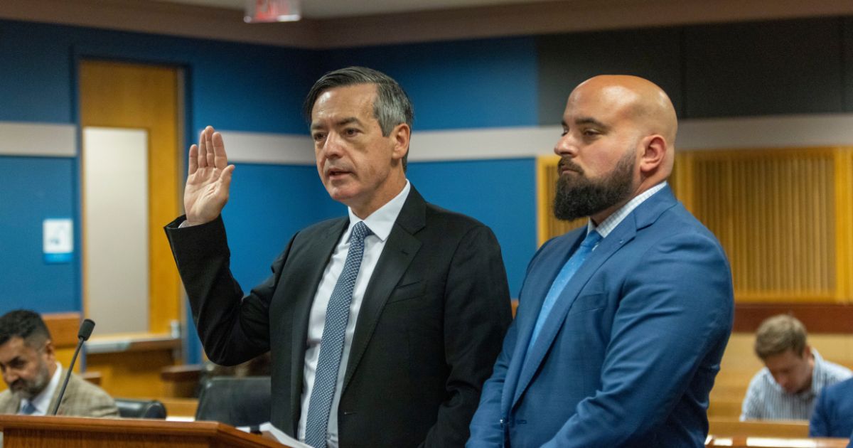 Attorney Scott Grubman (R) stands with his client, Kenneth Chesebro, as Chesebro is sworn in during a plea deal hearing in front of Fulton County Superior Judge Scott McAfee at the Fulton County Courthouse October 20, 2023 in Atlanta, Georgia.