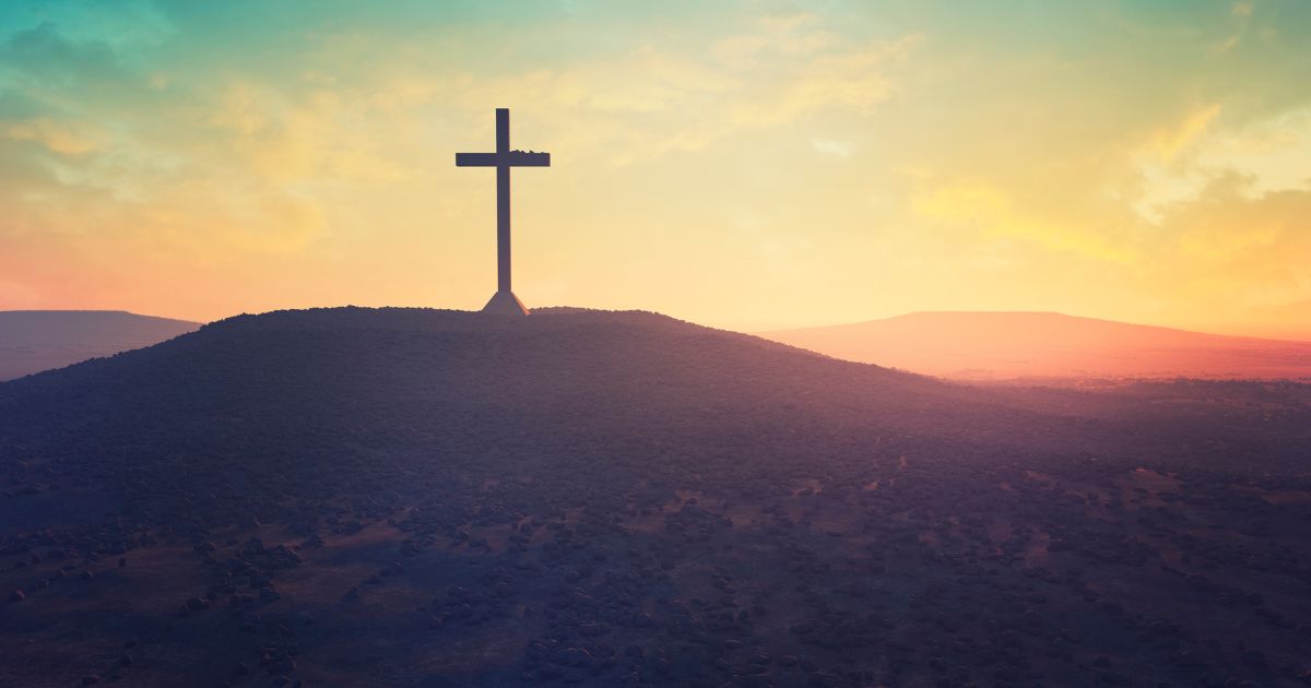 This stock image shows a cross in a desert.
