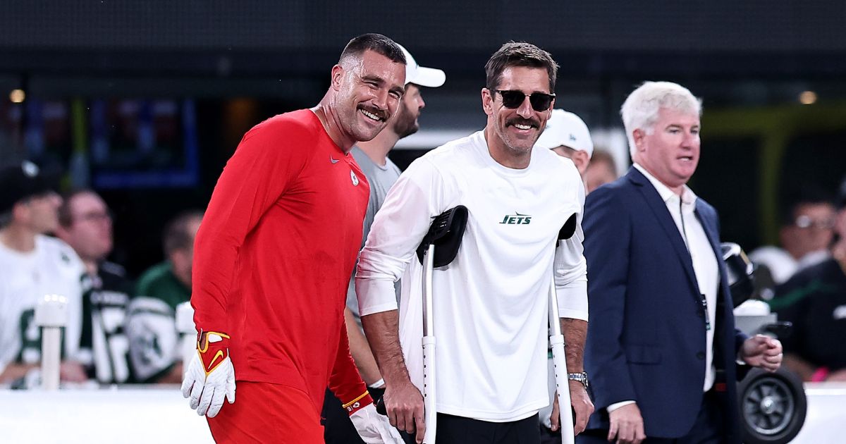 Travis Kelce #87 of the Kansas City Chiefs talks with injured Aaron Rodgers #8 of the New York Jets prior to the game at MetLife Stadium on Sunday in East Rutherford, New Jersey.