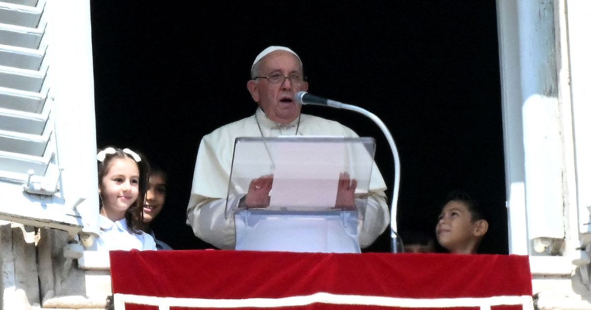 Pope Francis delivers a speech to the pilgrims flanked by children from the five continents during the Sunday Angelus prayer in St.Peter's Square at the Vatican on Sunday.