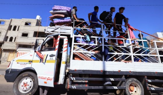 A truck transports a Palestinian family and their belongings on Sunday to Khan Yunis, in the southern Gaza Strip. Israeli forces are preparing for an invasion of the territory after the Oct. 7 massive terrrorist attack by the group Hamas, which governs Gaza.