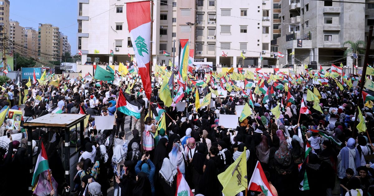 Hezbollah supporters gather during a rally in Beirut on October 13, 2023, as thousands of protesters poured onto the streets of several Middle East capitals in support of Palestinians amid Israeli air strikes on Gaza in reprisal for a surprise Hamas attack.