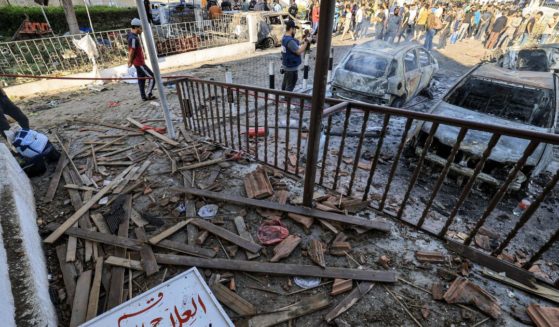 People search through debris outside the site of the Ahli Arab hospital in Gaza City on Wednesday in the aftermath of an overnight strike there.