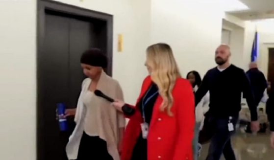 U.S. Rep. Ilhan Omar is questioned in a Capitol HIll hallway by Fox Business reporter Hillary Vaughn.