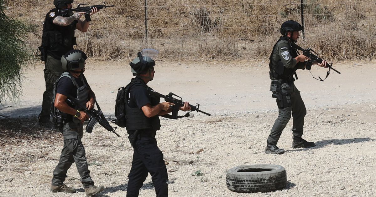 Israeli forces, dispatched to the border with Gaza in southern Israel, scan the area near Ashdod on Sunday as the battle against holdout Hamas fighters continues.