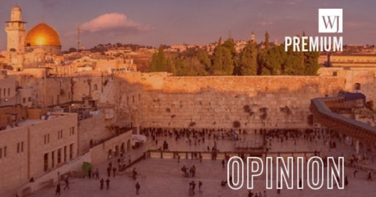 The Western Wall in Jerusalem with the dome of Temple Mount, left.