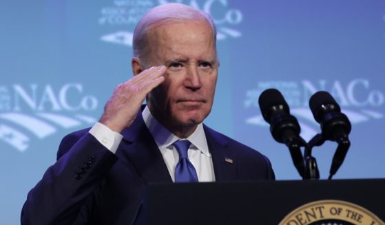 President Joe Biden salutes during an address at the National Association of Counties legislative conference at the Washington Hilton Hotel in February in Washington.