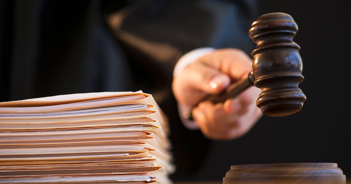 This stock image shows a gavel being held by a judge.