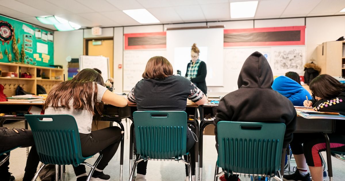 Students sit in class in this stock image.