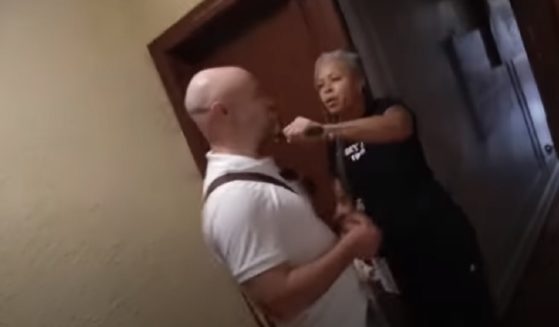 Shellyne Rodriguez, then a professor at Hunter College in New York, holds a blade to the throat of a New York Post reporter in a May video.